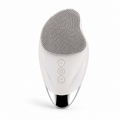 silicone facial cleansing brush with soft textured bristles and chrome accent base displayed on a white background.