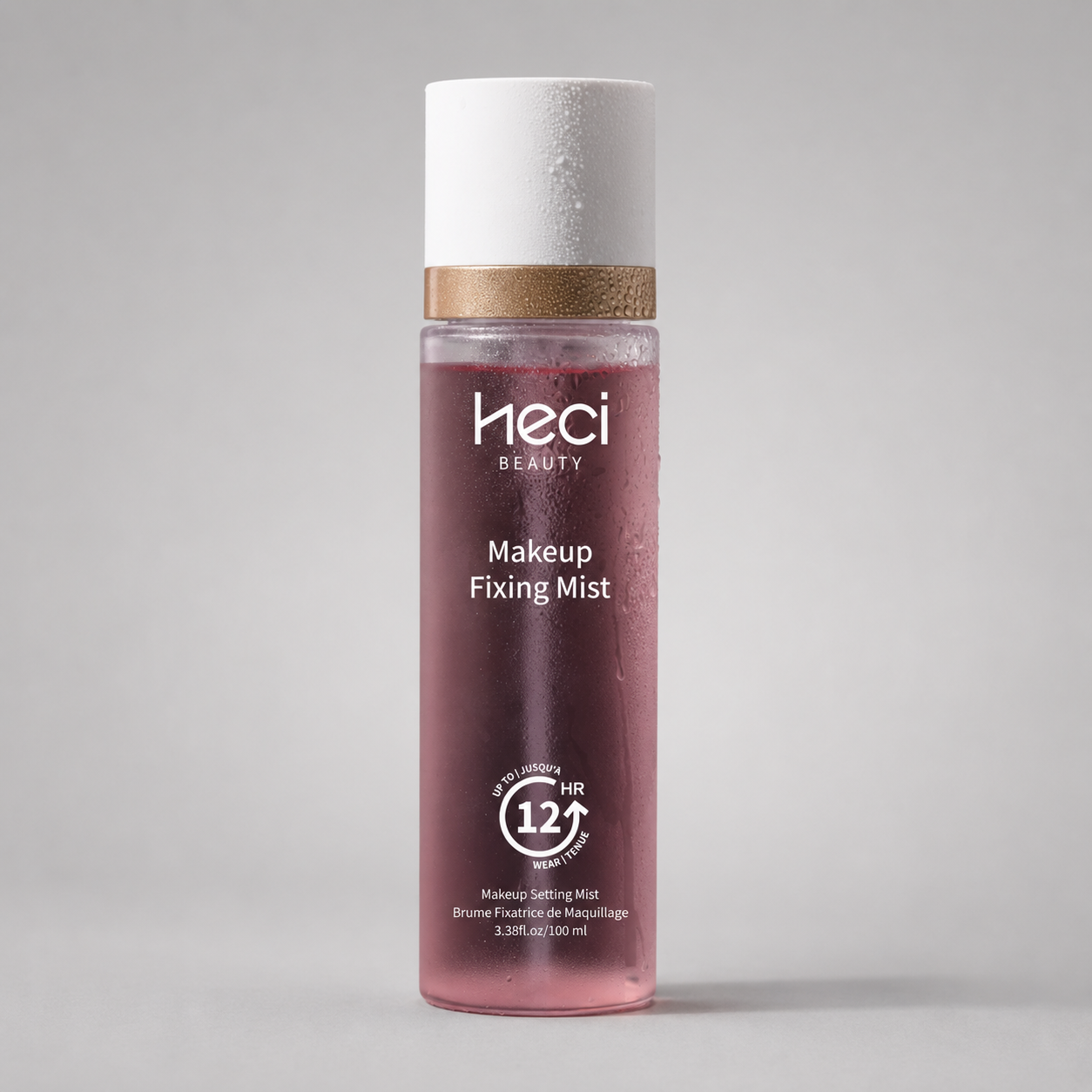 Heci Beauty Makeup Fixing Mist 12 Hour Long Lasting Hydrating Setting Spray applied by model on pink background